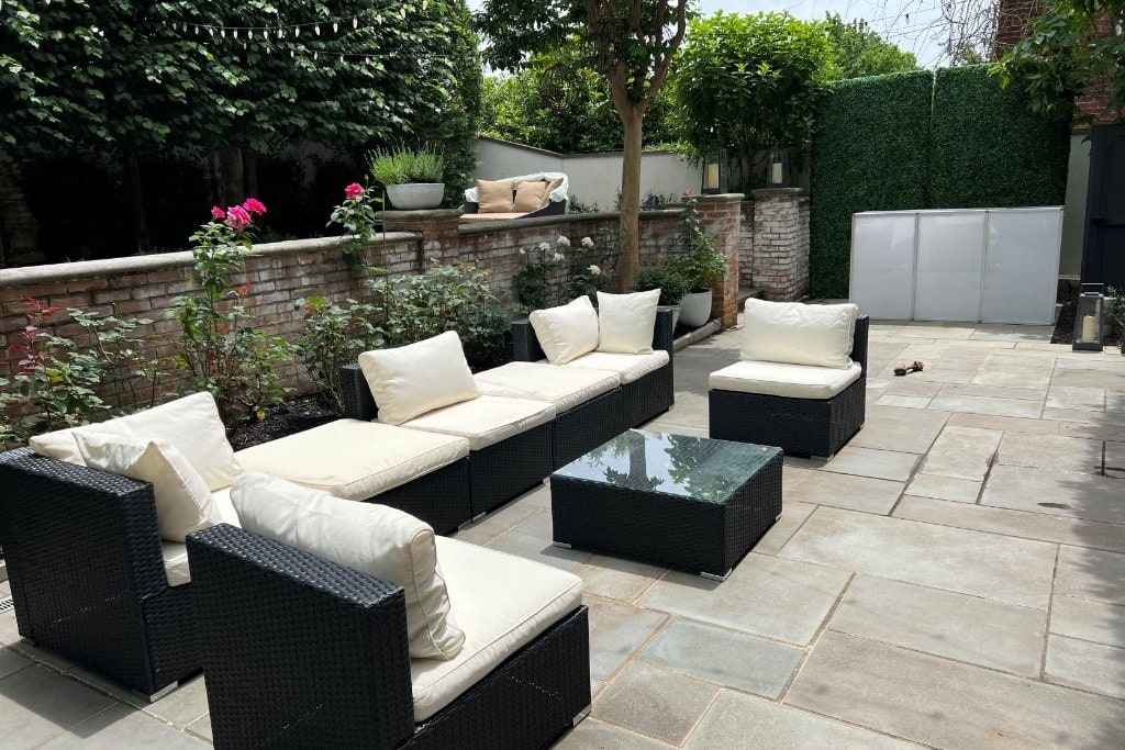 Sonoma outdoor rattan lounge set with cream cushions on a stone patio