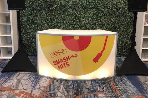 Branded curved bar with Smash-ing Hits graphic and styled hospitality service station