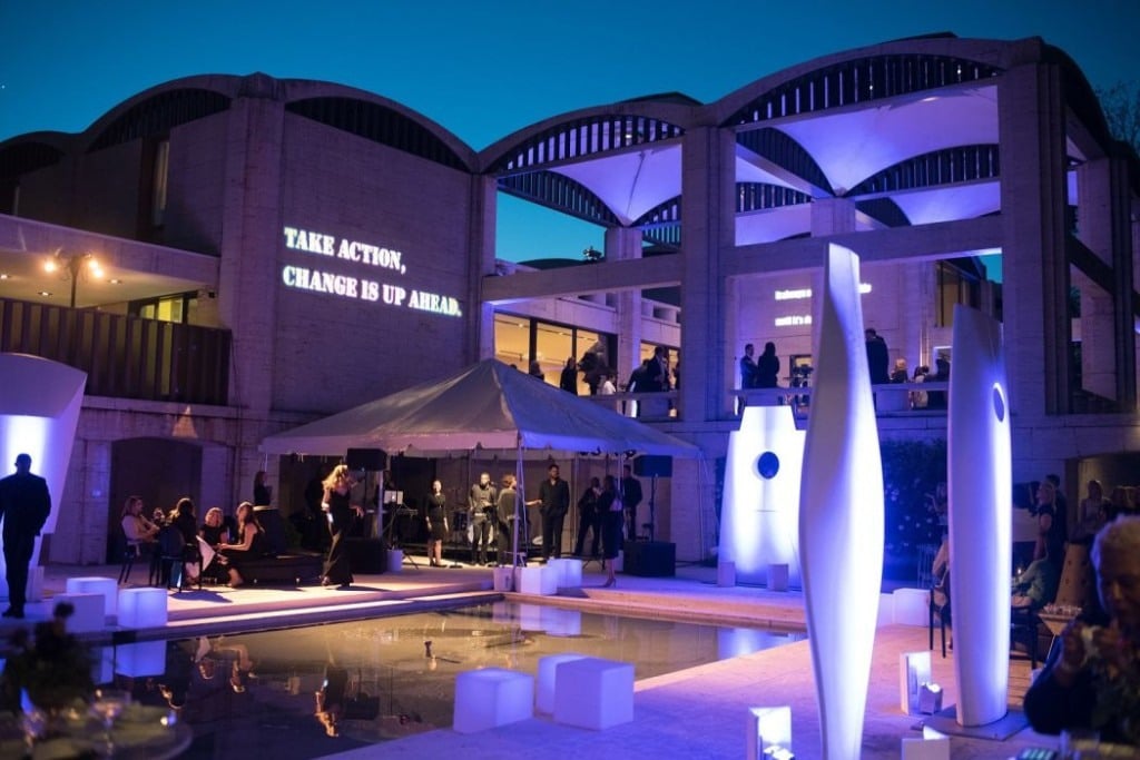 Outdoor experiential activation with illuminated architecture, reflecting pool, and projected messaging Outdoor experiential activation with illuminated architecture, reflecting pool, and projected messaging
