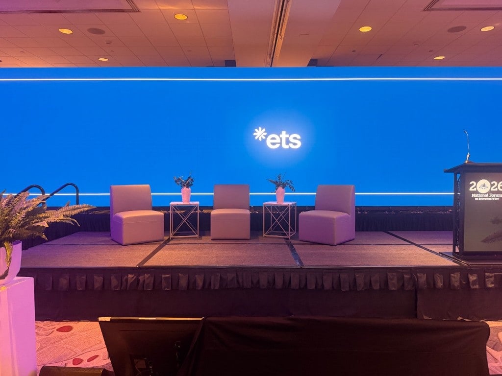 ETS National Forum stage with panel seating, podium, and branded blue LED backdrop ETS National Forum stage with panel seating, podium, and branded blue LED backdrop