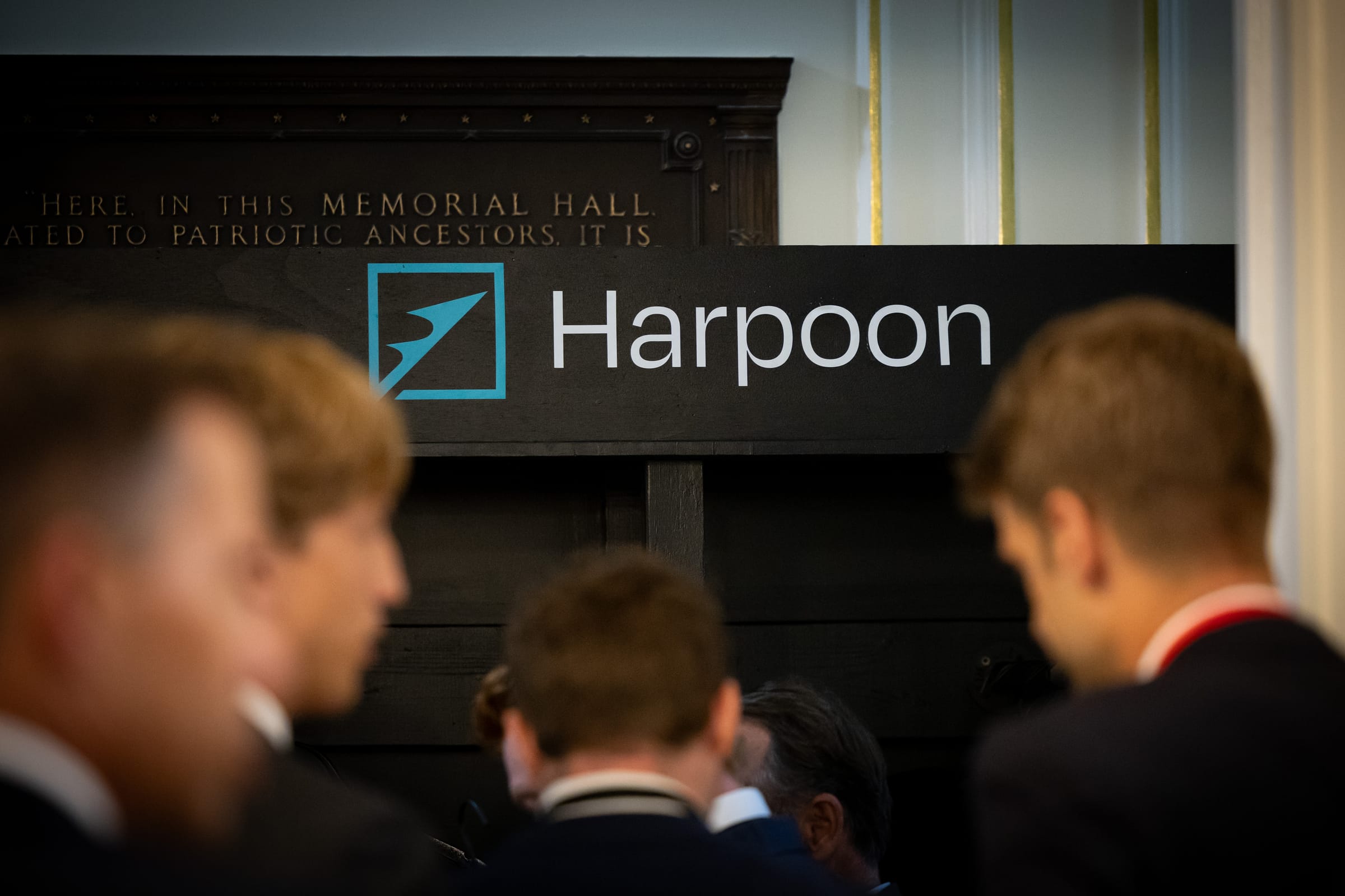 Harpoon branded retail display signage Harpoon branded header on the custom retail display with summit guests in the foreground