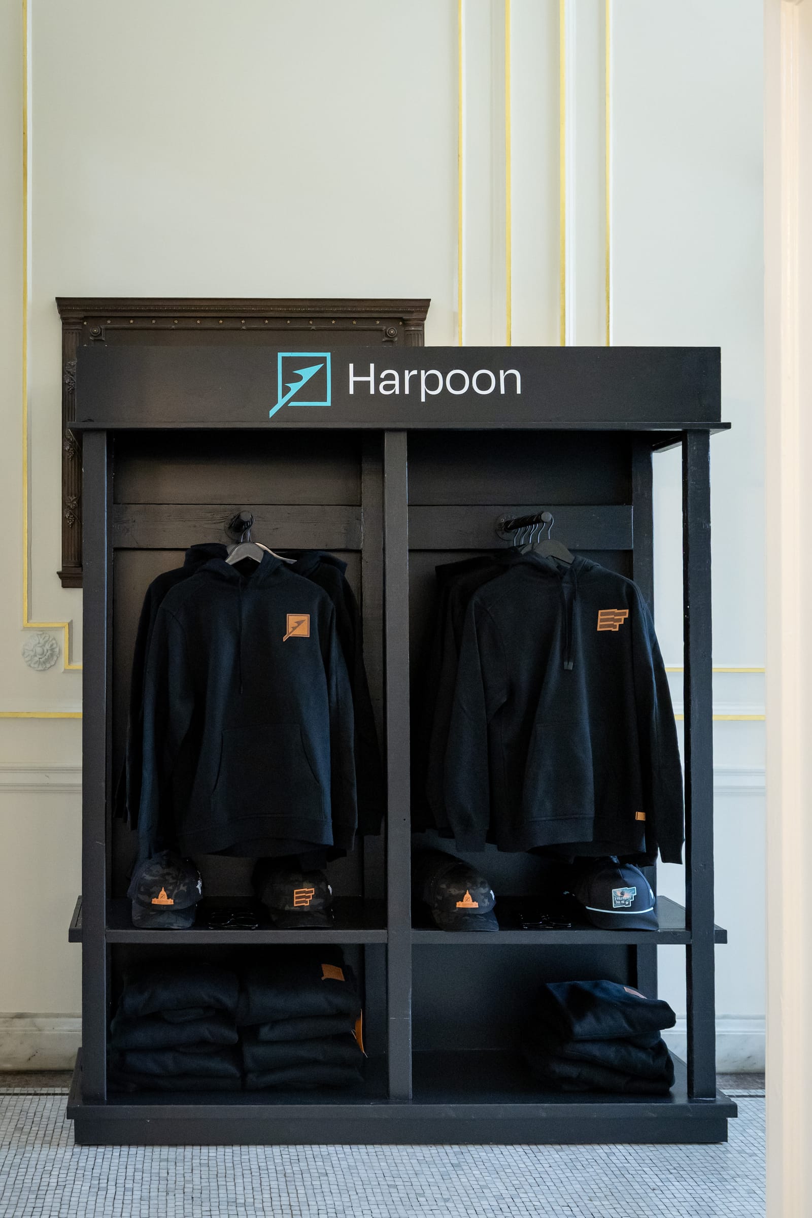 Custom Harpoon retail display Custom fabricated black Harpoon retail display with branded hoodies, caps, and folded apparel